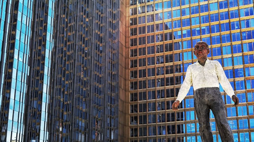 Low angle view of man standing in city