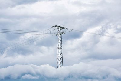 Low angle view of electricity pylon against sky