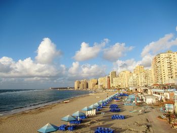 Panoramic view of beach and buildings against sky