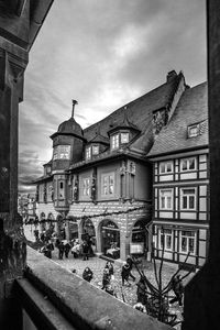 Buildings in town against cloudy sky