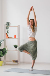 Full length of woman standing at home