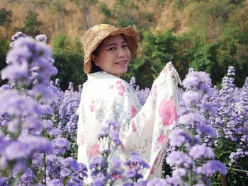 Woman standing on purple flowering plants