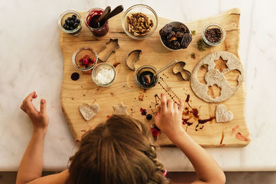 High angle view of woman preparing food on table