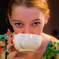 Close-up portrait of woman drinking coffee