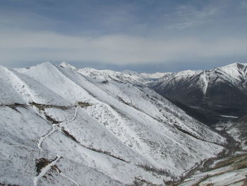 Scenic view of snowcapped mountains against sky