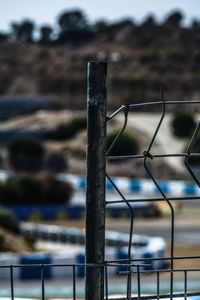 Close-up of fence against road