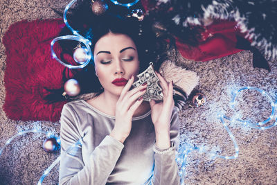 Full length of woman holding christmas tree