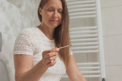 Portrait of young woman writing in book