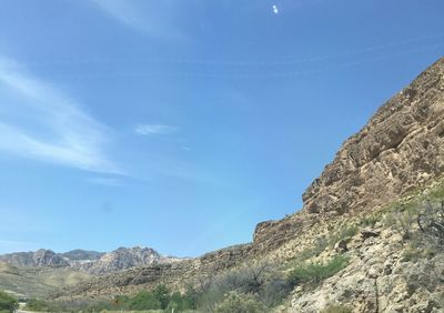 Low angle view of mountain against blue sky