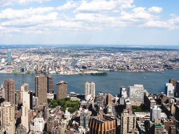 High angle view of cityscape against cloudy sky