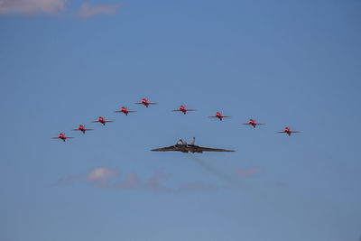 Low angle view of airshow against sky