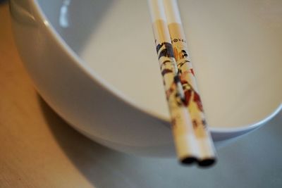 Close-up of chopsticks on bowl