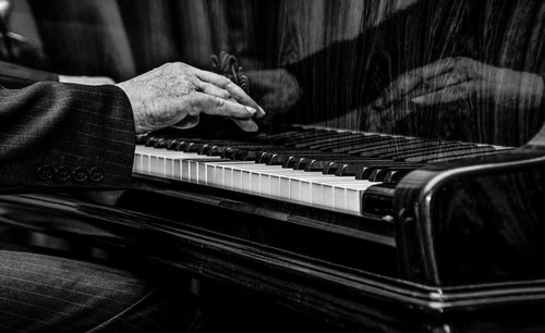 Cropped image of man playing piano