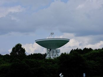 Low angle view of communications tower against sky
