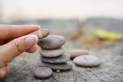 Close-up of human hand on stone