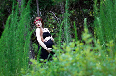 Portrait of a smiling young woman in forest