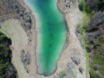 High angle view of river amidst mountains against sky