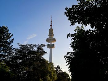 Low angle view of tower and buildings against sky