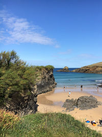 Scenic view of beach against blue sky