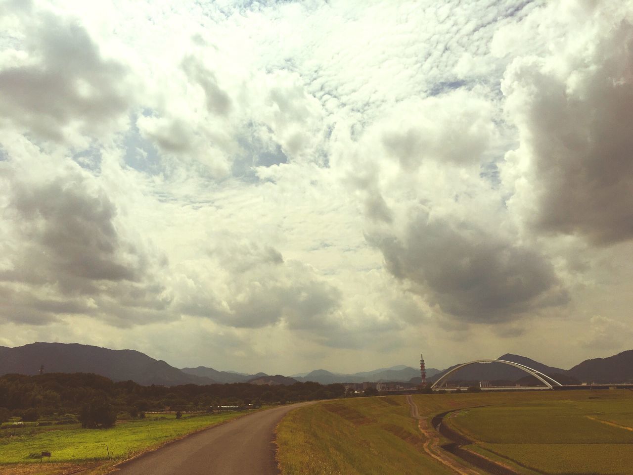 road, cloud - sky, transportation, sky, landscape, the way forward, day, scenics, no people, nature, outdoors, tranquility, land vehicle, beauty in nature, mountain, storm cloud, winding road