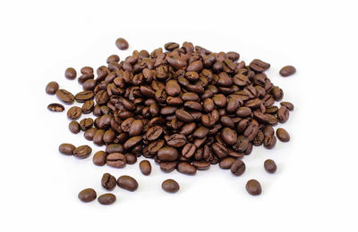 High angle view of coffee beans on white background