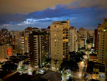 High angle view of illuminated buildings against sky at dusk