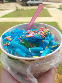 Close-up of hand holding ice cream