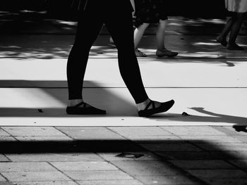 Low section of people walking on footpath