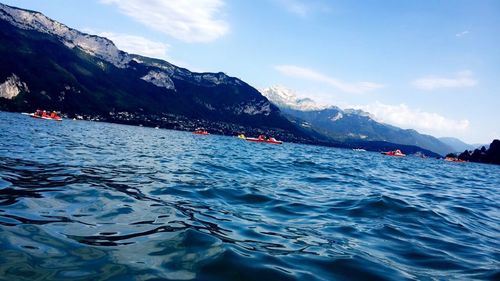 Scenic view of sea and mountains against sky