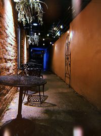 Empty chairs and tables in illuminated building