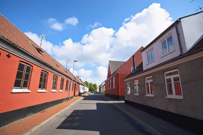 Street amidst buildings against sky