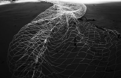 High angle view of fishing net on beach