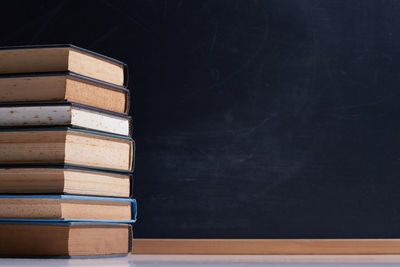 Stack of books against black background