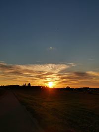 Scenic view of field against sky during sunset