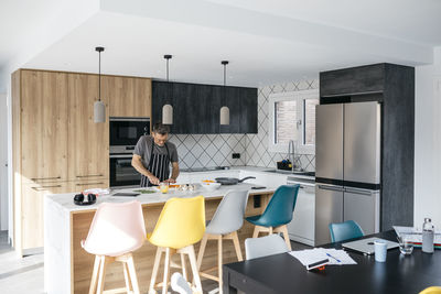 Man cooking food in kitchen at home