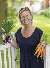 Woman with bunches of vegetables