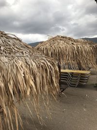 Hay bales on field against sky