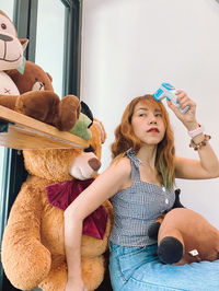 Cute girl sitting with toy at home