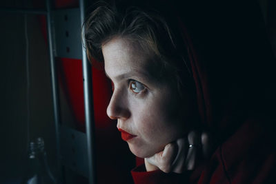 Close-up of thoughtful woman with hand on chin