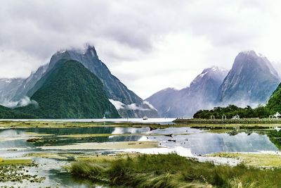 Scenic view of lake and mountains against sky