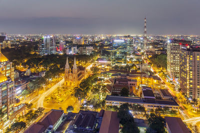 High angle view of city lit up at night