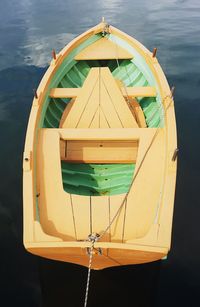 Close-up of yellow boat hanging over sea against sky