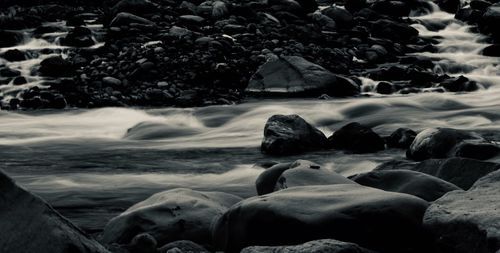 Rocks on beach against sky