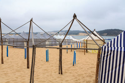 Lifeguard hut on beach against sky