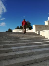 Low angle view of man walking on stairs