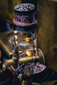 Close-up of illuminated tea light candles in temple