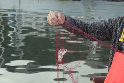 Rear view of woman holding water