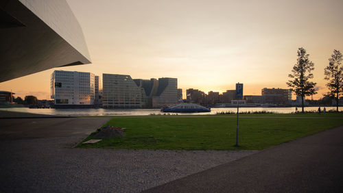 View of city buildings against sky during sunset