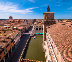 View from the castello estense over the green moat towards the cathedral in ferrara, italy