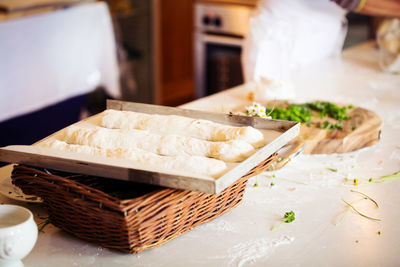 High angle view of dough in tray at kitchen counter